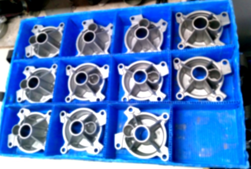 Top-down view of automotive components arranged in AVL PP returnable packaging crate
